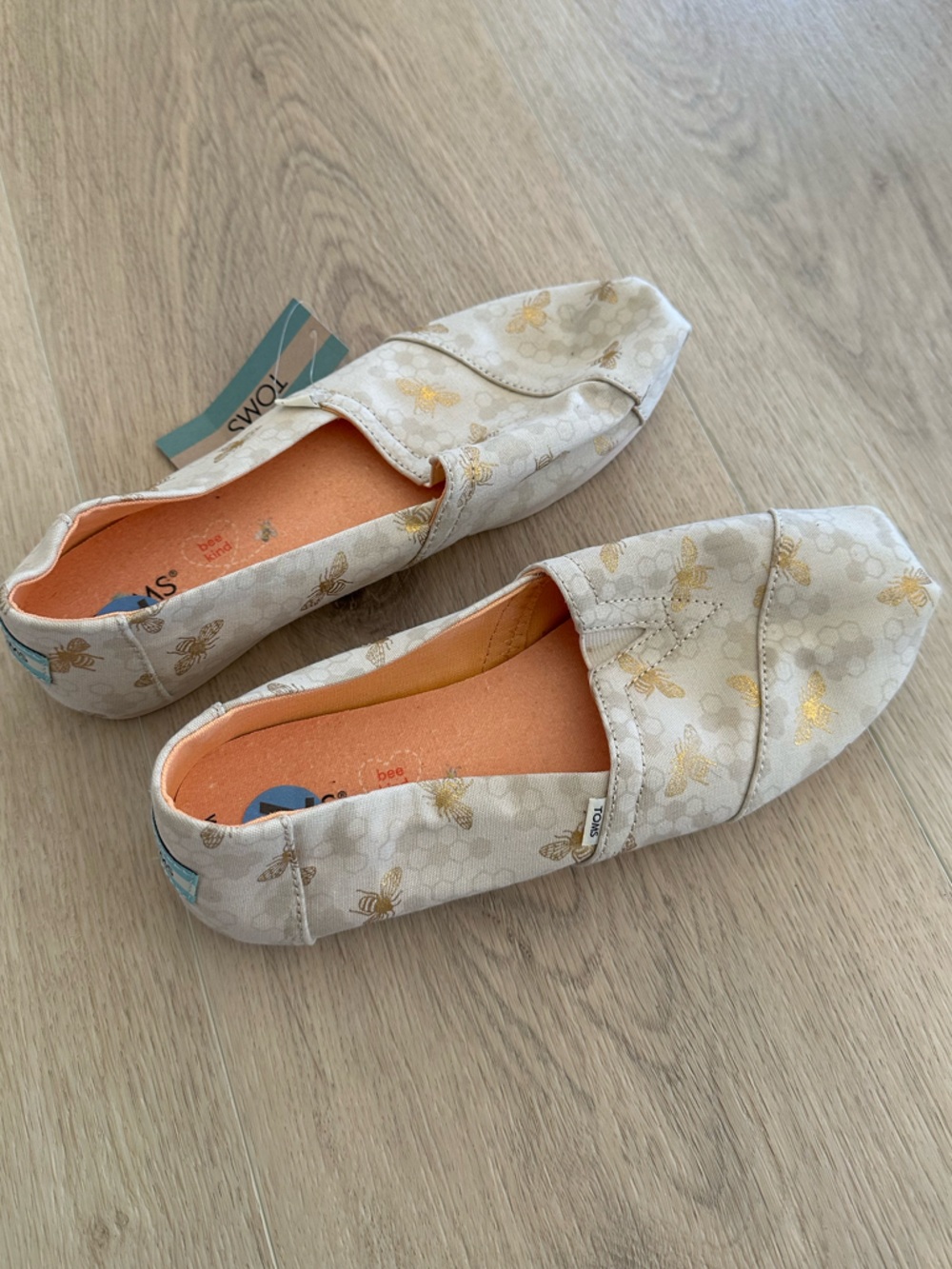 TOMS Women’s Beige Slip-On Alpargata with Metallic Gold Bee Print